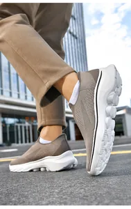 Outdoor shot of brown slip-on walking shoes for men featuring breathable knit mesh