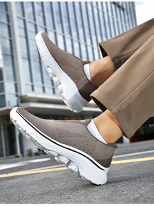 Close-up of brown slip-on walking shoes with breathable knit and anti-slip white sole