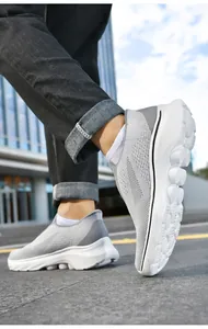 Close-up of grey slip-on walking shoe with breathable knit mesh and flexible white sole
