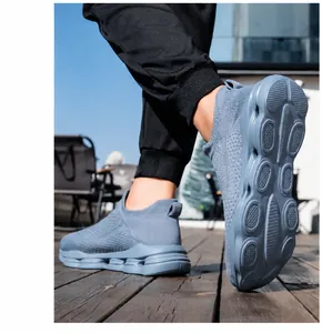 Detail of grey-blue breathable flyknit walking shoe with shock-absorbing thick sole