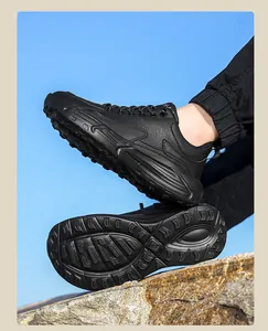 Detailed side view of black leather outdoor sneakers with anti-slip tread and thick sole