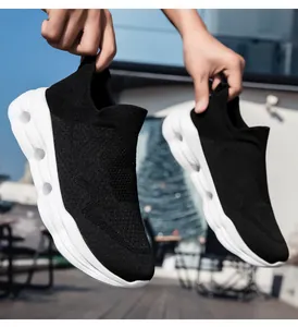 Detailed view of black breathable knit upper and white thick sole with hollow shock holes