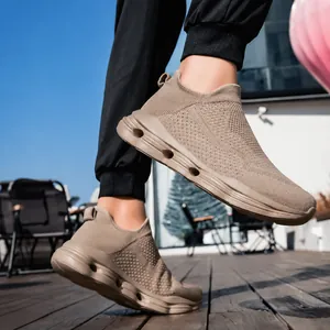 Outdoor view of khaki slip-on walking shoe featuring breathable knit and cushioned sole