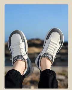 Detail of leather casual sneakers with elastic laces on feet against a blue sky background