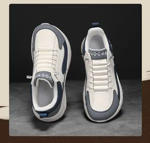 Top view of cream leather sports shoes featuring navy blue and grey stitching details