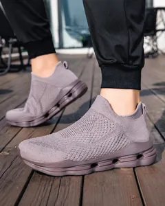 Detail of grey-purple fly-knit outdoor sneaker showing breathable mesh and thick cushioned sole