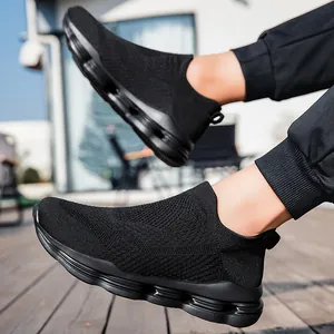 Breathable black knit slip-on walking shoes with geometric cushioning sole on feet