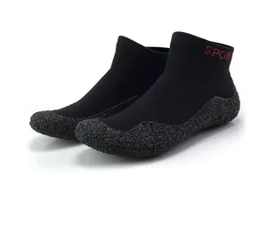 Close-up of black barefoot shoe featuring elastic knit fabric and anti-slip rubber sole