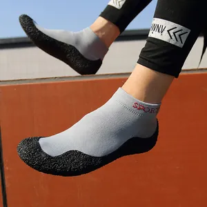 Lightweight grey barefoot water shoes with non-slip rubber soles and breathable knit fabric