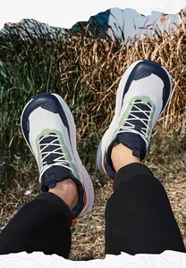 Detail view of breathable wide-toe mesh sneakers with stylish colorful leather overlays