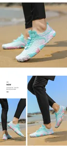 Detail of mint green water shoes with quick-dry mesh and non-slip rubber soles on beach