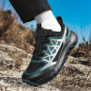 Outdoor hiking sneaker with breathable black mesh and thick non-slip sole on rocky terrain