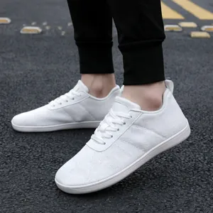 White breathable mesh sneakers for men and women on a road background in a lifestyle view
