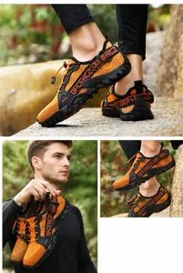 Detail of orange mesh hiking shoes with drawstring laces and rugged rubber soles