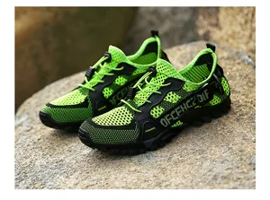 Detailed macro view of breathable mesh texture and non-slip rubber sole of trekking shoes