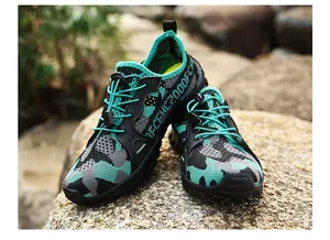 Close-up of breathable mesh upper and elastic drawstring laces on outdoor hiking shoes