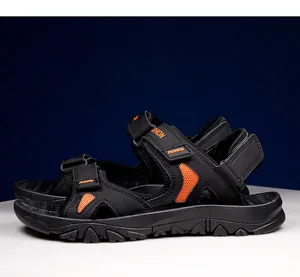 Detail view of men's hiking sandals with adjustable orange velcro straps and grip sole