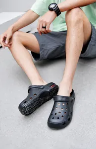 Detail of men's breathable black garden clogs featuring red air cushion and heel strap