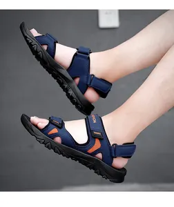 Detail of navy blue men's outdoor sandals with non-slip rubber soles and orange mesh