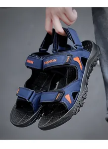 Detail of men's blue sports sandals featuring adjustable velcro straps and non-slip sole