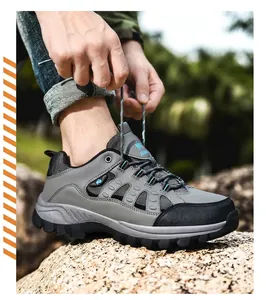 Detail shot of a person tying laces on durable trekking boots in an outdoor setting