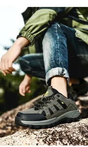 Detail shot of hiking boot showing ankle support and grippy rubber sole in nature