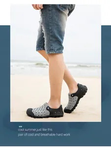 Close-up of grey breathable beach clogs with circular vents and flexible black soles