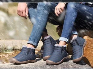 Detail view of waterproof snow boots with thick grey plush lining and anti-slip rubber soles