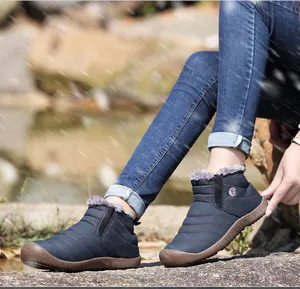 Detail view of waterproof navy snow boot with thick faux fur lining and non-slip sole
