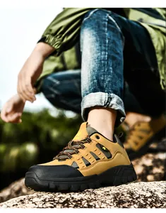 Outdoor hiking shoes with durable MD soles shown on a rocky mountain terrain