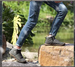 Outdoor close-up of waterproof snow boots with quilted fabric and thick faux fur lining
