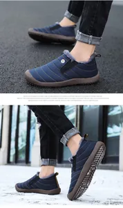 Deep blue thermal winter shoes with quilted fabric and thick anti-slip sole shown in snow