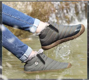 Outdoor shot showing waterproof snow boots splashing water to display resistance