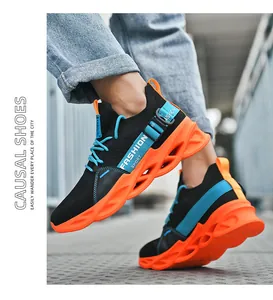 Side view of lightweight blade running shoes featuring black knit and vibrant orange soles