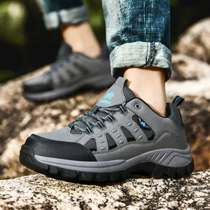 Outdoor hiking shoes with gray and black panels and durable MD sole on rocky terrain