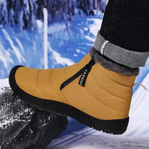 Detail of ginger waterproof snow boot featuring black side zipper and thick faux fur lining
