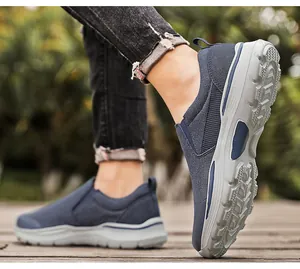 Gros plan de chaussures en toile bleu foncé pour hommes avec semelles épaisses sur bois