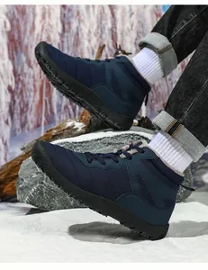 Detailed view of non-slip rubber soles on blue waterproof winter snow boots