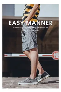 Outdoor shot of men's casual outfit with gray slip-on canvas shoes and striped T-shirt
