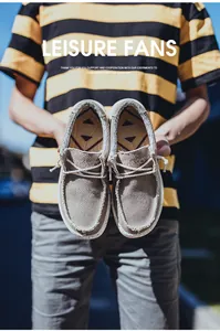 Detail of light brown canvas loafer with white laces and anti-slip rubber sole