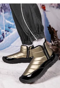 Close-up of golden quilted snow boots featuring side zipper and durable rubber sole