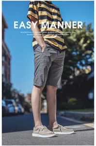 Street style shot of men's grey casual cotton shorts with pockets and rolled hem design