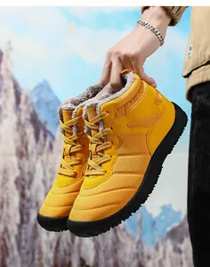 Detail of yellow waterproof snow boots featuring thick grey faux fur lining for winter