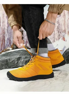 Detail showing bright yellow winter snow boots with warm faux fur lining and anti-slip sole