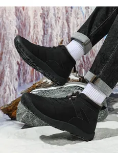 Detail of waterproof winter snow boots with warm faux fur lining on a snowy outdoor background