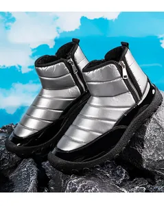 Detailed view of silver metallic snow boots with quilted texture and warm fleece lining