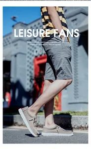 Street style view of men's beige canvas loafers paired with striped tee and shorts