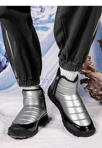 Silver quilted snow boot with side zippers and non-slip rubber sole in outdoor winter scenery