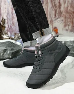Outdoor close-up of waterproof grey winter boots with plush lining and anti-slip rubber soles