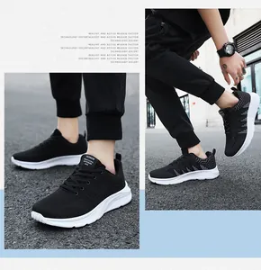 Detail of black breathable knit sneakers with thick white EVA sole on asphalt street
